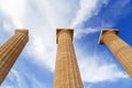 Three ancient greek pillars against blue sky