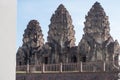 Three ancient Khmer-style stone prangs of a temple under a blue sky, an architectural heritage site. Historic Royalty Free Stock Photo