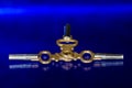 Three Antique Brass Pocket Watch Keys Laying on Blue Surface Royalty Free Stock Photo