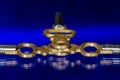 Three Antique Brass Pocket Watch Keys Laying on Blue Surface Royalty Free Stock Photo