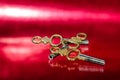 Three Antique Brass Pocket Watch Keys Laying on Red Surface Royalty Free Stock Photo