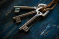 Three antique keys on wooden table Royalty Free Stock Photo