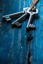 Three antique keys on wooden table Royalty Free Stock Photo