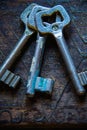 Three antique keys on wooden table Royalty Free Stock Photo