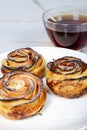 Three apple tartlets on plate and cup of tea