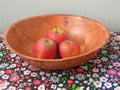 Three apples on a bamboo plate. Still life.