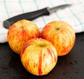 Three Apples on a Black Slate serving board Royalty Free Stock Photo