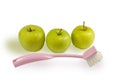 Three apples and brush for washing of fruit Royalty Free Stock Photo