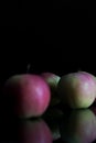 Three apples with drops of water. on a black background. Royalty Free Stock Photo