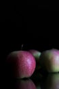 Three apples with drops of water. on a black background. Royalty Free Stock Photo