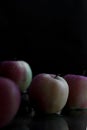 Three apples with drops of water. on a black background. Royalty Free Stock Photo