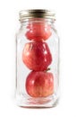 Three apples in a glass mason jar for canning