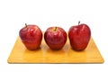 three apples isolated place on woodden cutting board