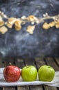 Three apples on the old dark table village