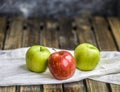 Three apples on the old dark table village Royalty Free Stock Photo