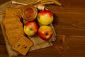 Three apples, slices of rye bread, honey, wheat ears on sacking Royalty Free Stock Photo