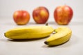 Three Apples and Two Bananas on a Gray White Grey Marble Slate Background Royalty Free Stock Photo