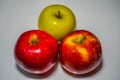 Three apples, two red and one green. Royalty Free Stock Photo