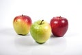 Three apples on a white background with water drops Royalty Free Stock Photo