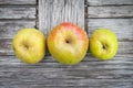 Three apples on a wooden table, top view Royalty Free Stock Photo
