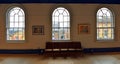 Three Arched Windows and bench from inside looking out.