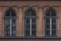 Three arched windows on an old ornate facade Royalty Free Stock Photo