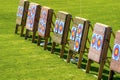 Three archery targets in a row in a grass field on a sunny day