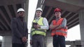 Three architects in protective helmets looking at camera Royalty Free Stock Photo