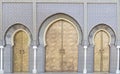 Three archways and closed golden doors in a palace