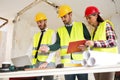 Three arhitects working together on construction site project Royalty Free Stock Photo