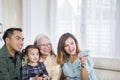 Three Asian generation family watching TV at home Royalty Free Stock Photo