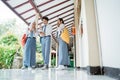 Three Asian high school students enthusiastically use one smartphone to view joint announcements