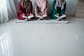 Three asian moslem woman read and learn the holy book of the Al-Quran together