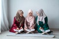 Three asian moslem woman read and learn the holy book of the Al-Quran together