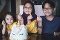 Three Asian siblings celebrating birthday at home. Happy together