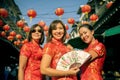 Three asian woman wearing chinese tradition clothes toothy smiling face in yaowarat street china bangkok thailand