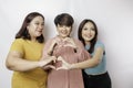 Three Asian women feel happy and a romantic shapes heart gesture expresses tender feelings, close friendship concept