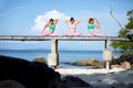 Three asian woman playing yoga pose on beach pier Royalty Free Stock Photo