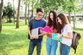 Three Asian young campus students enjoy tutoring and reading boo Royalty Free Stock Photo