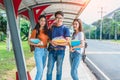 Three Asian young campus students enjoy tutoring and reading boo Royalty Free Stock Photo