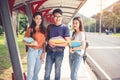 Three Asian young campus students enjoy tutoring and reading books together. Friendship and Education concept. Campus school and Royalty Free Stock Photo