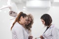 Three assistant females talking to each other duirng the brakes at dentistry Royalty Free Stock Photo