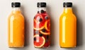 Three assorted fresh fruit juices in glass bottles with black caps on a neutral background, representing healthy dietary Royalty Free Stock Photo