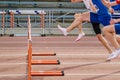 three athlete runners running together 100 meters hurdles race