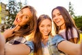 Three attractive cheerful best girlfriends with toothy smile making selfie photo and rest on weekend Royalty Free Stock Photo