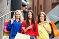Three attractive happy female friends walking in the city center with shopping bags Royalty Free Stock Photo