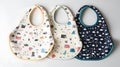Three baby bibs with different patterns and colors Royalty Free Stock Photo