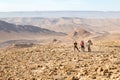 Three backpackers standing mountains trail , Negev desert, Isra Royalty Free Stock Photo