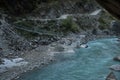 Three backpackers walking across a suspension bridge