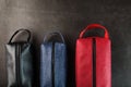 Three bags, black, blue and red with genuine leather locks on a black background Royalty Free Stock Photo